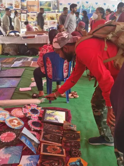 Duplicate of 106, showing a visitor at my stall.