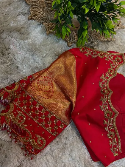 Another angle of the red blouse, highlighting the detailed craftsmanship of the hand-stitched embroidery.