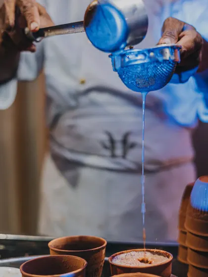 Nothing beats a garam garam chai, especially when it's pouring outside. A chai-wallah strains fresh masala tea into traditional kulhads, a comforting experience I love to bring to events.