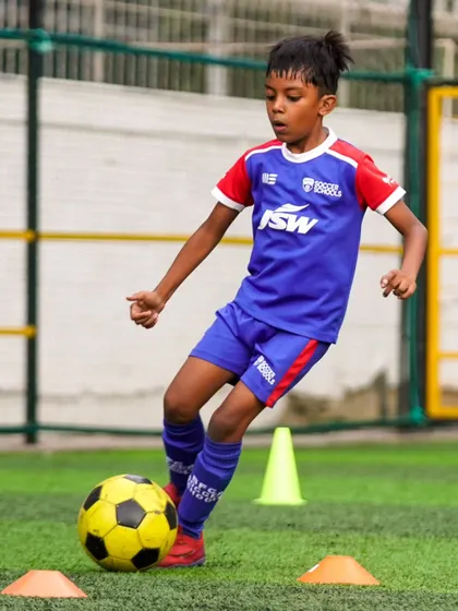 A player navigates a cone drill, a staple of our training program to improve agility and ball control.