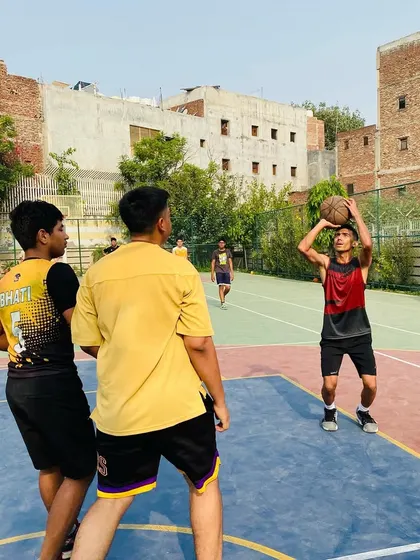 A player takes an open shot while teammates look on. We teach spacing and finding the best scoring opportunity.