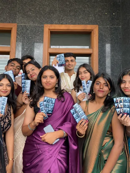 A large group of friends from Akash Group of Institutions, all holding up their photo strips.