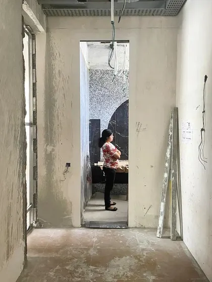 Good design is about more than just finishes; it's about the careful consideration of scale and proportion. This on-site moment captures our deliberation over a doorway, ensuring its height and width are in harmony with the human body and create the desired spatial experience.
