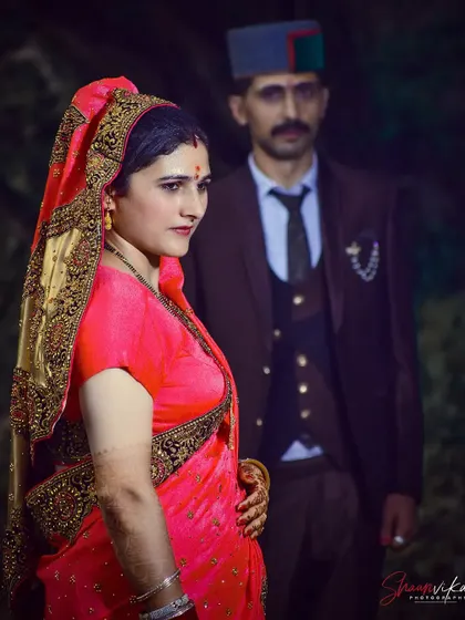 A dramatic couple's portrait with the bride in the foreground and the groom slightly out of focus behind her. This technique creates depth and tells a story.