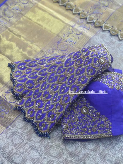 The sleeves of the purple blouse, showing the scale-like feather pattern.