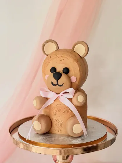 This fully sculpted 3D teddy bear cake is as delicious as it is cute. I shaped the layered cake and used textured buttercream to create the fur, finishing it with a simple pink bow. It's a perfect example of how a cake can be both a sculpture and a treat.