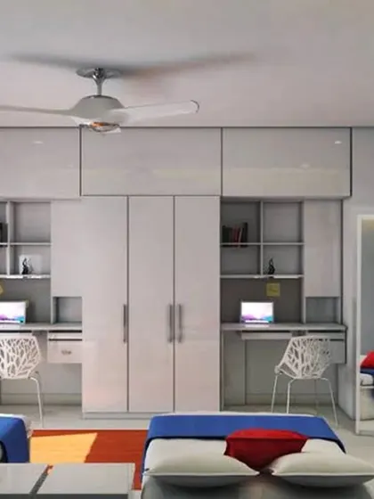 A clean and symmetrical design for two children sharing a room. Each child gets their own bed and a dedicated desk space, with a shared central wardrobe to maximize storage.