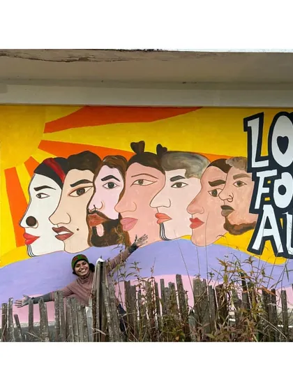 A collage of my murals from the 2024 Travelling Arts and Film Festival. Posing with my "Love For All" piece in Ziro, a mural that celebrates diversity and inclusion.