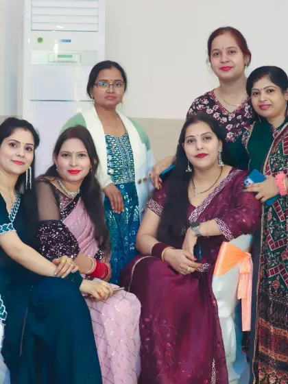 A group of female guests dressed in elegant sarees and suits pose for a photo. We document the guests and the festive fashion at your event.