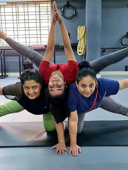 A fun and creative moment in our yoga class. Our members and trainer work together to create a beautiful group pose, showcasing teamwork and flexibility.
