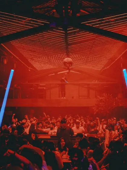 The view from the second floor at Xora, looking down at a sea of people under red lights. An absolutely packed house.