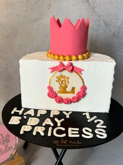 Another adorable half-birthday cake for a little princess. This half-rectangle cake is topped with an edible pink crown.