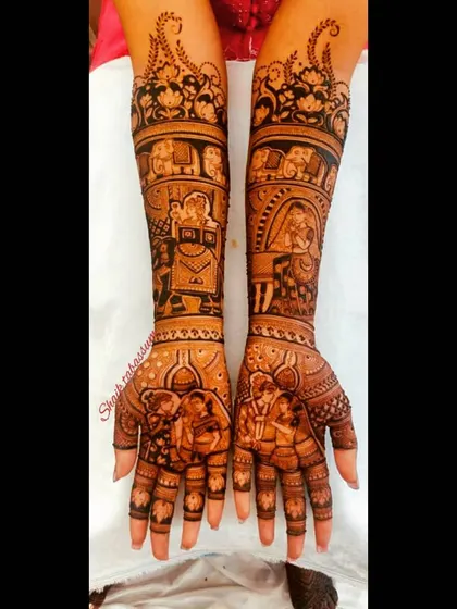 A grand bridal mehendi depicting a full wedding procession. The design includes elephants, a doli, and various figures, leading up to the couple's portrait on the palms.