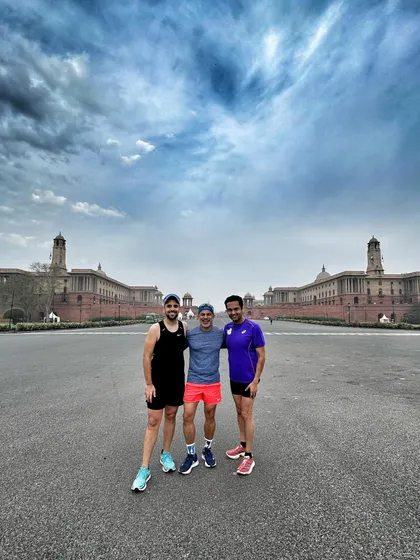 Three of our runners posing in front of Rashtrapati Bhavan after a Sunday run. The dramatic sky adds to the epic feeling of accomplishment.