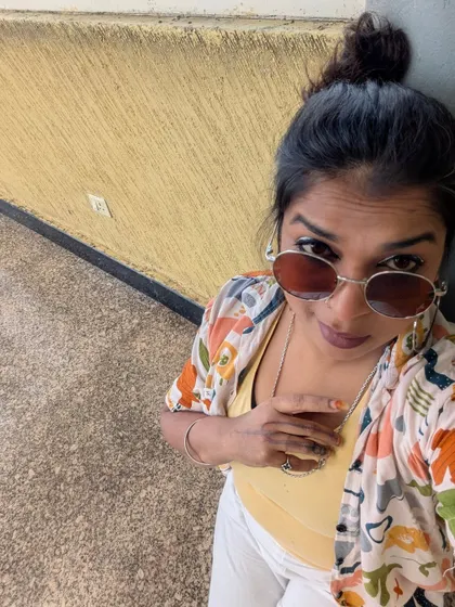 Leaning against a wall, taking a moment for myself. Sharing my vulnerability is scary, but it also connects us.