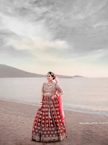 A breathtaking bridal portrait on the beach. The bride stands against the vast ocean and sky, a picture of elegance and dreams.