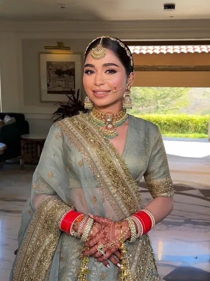 A beautiful Sikh bride ready for her Anand Karaj ceremony. Her hair is styled in a clean, traditional braid, ready to be covered by her dupatta.