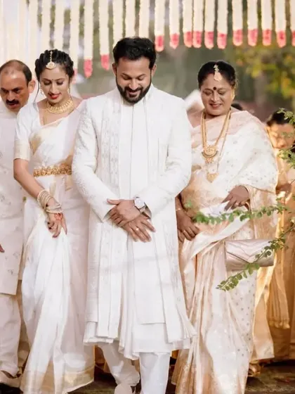 The groom and his family making their entrance during the traditional South Indian wedding procession.