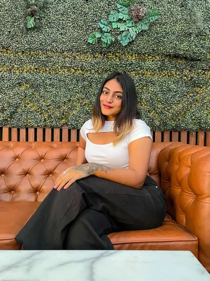 A smiling shot in my casual cheat day outfit. The combination of a white top and black pants is a timeless classic.