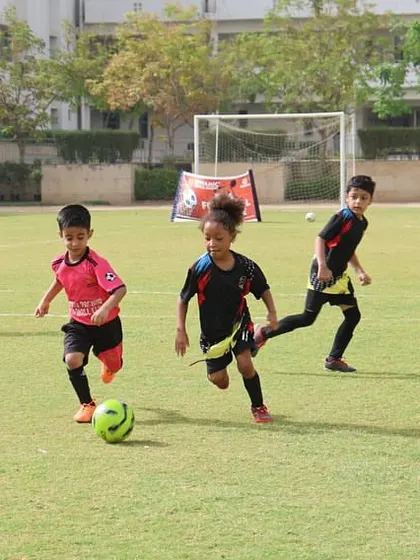 Young players chase the ball during an energetic league match.