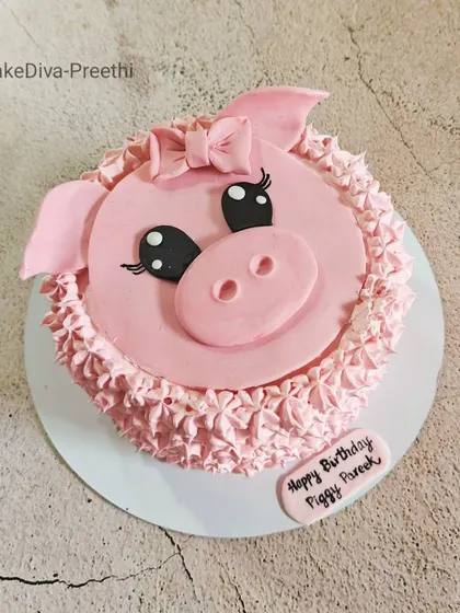 Another view of the cute piggy cake. This design is a great example of combining simple fondant work with buttercream piping techniques for a charming result.