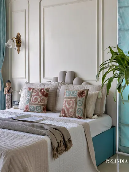 Softness in every corner, sophistication in every detail. This dreamy bedroom blends classic design, with its intricately carved moldings and pastel blue accents, with the calming energy of a modern sanctuary.