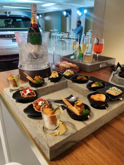 A close-up of the futuristic canapés served at the new Range Rover launch. We used custom cinder-blanched service trays to present bites like yoghurt foams and ancient grain crackers, reflecting the vehicle's modern design.