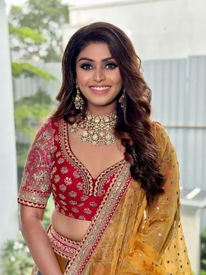 A happy and radiant portrait of the bride, her smile complemented by the beautiful, glamorous makeup.