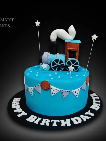 All aboard the birthday express! This bright blue cake is topped with a fondant steam train and decorated with a cute bunting design for a festive feel.