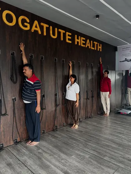 Using the wall to find perfect alignment in a side-body stretch. This simple prop provides immediate feedback for maintaining a straight line from the hand to the foot.