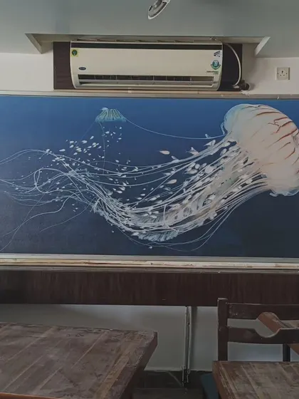 A beautiful mural of a jellyfish, framed and installed in a commercial space.
