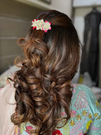Another angle of the bouncy curls, showing how the style has volume at the crown and cascades down. This look is perfect for a wedding guest who wants a polished yet glamorous hairstyle.