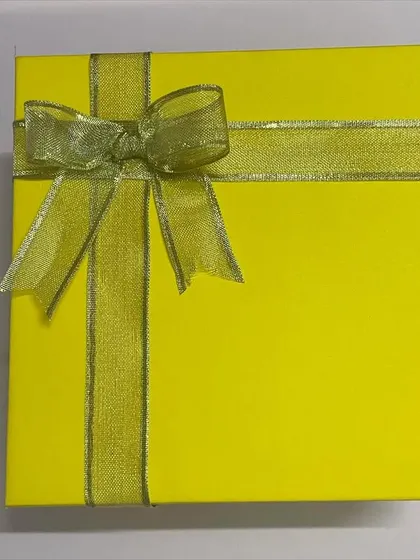 Even our simplest packaging is elegant. This yellow box is beautifully wrapped with a gold ribbon, ready to be gifted.