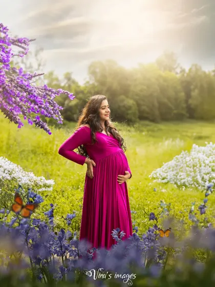 Surrounded by a field of purple and white flowers, this mother-to-be looks radiant. The addition of butterfly overlays adds a touch of fairytale magic to the natural scene.