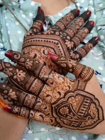 A shot of both hands, showing a different design on each, a popular trend for guests.