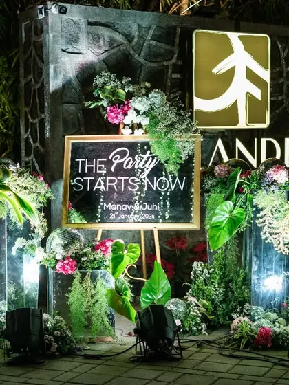 The welcome setup for the Sangeet after-party, with a sign that reads "The Party Starts Now," setting a fun and energetic mood.
