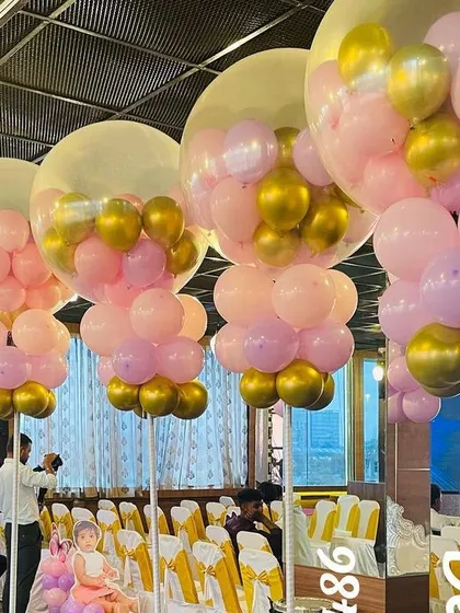Balloon decorations can transform a venue. For this event, we created large, eye-catching balloon arrangements using a combination of clear, pink, and gold balloons to add a touch of glamour and festivity to the space.