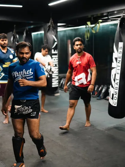 Fighters walk the mat, getting ready for the next drill in a busy class.