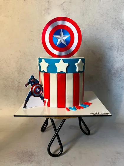 The full view of the Captain America fondant cake, showing its clean lines and bold colors. It's a perfect centerpiece for a superhero-themed birthday bash.