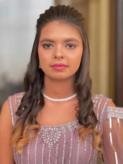 A front-on view of the soft party look, showing the subtle eye makeup and the pretty pink lip color.