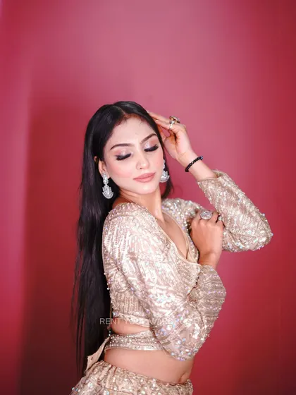 A portrait in the golden lehenga, capturing a moment of elegance.