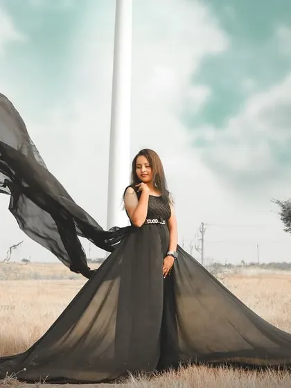 Make a bold statement with a black trail gown. This pre-wedding shot shows how the long, flying fabric can create powerful and dramatic shapes against an open landscape, giving your photos a high-fashion feel.