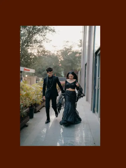 The couple walking hand-in-hand at their reception. The motion in the bride's dress and their happy stride capture the energy of the celebration.