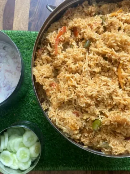 Biryani, raita and cucumber salad are ready together for our birthday dinner order for 25 members.