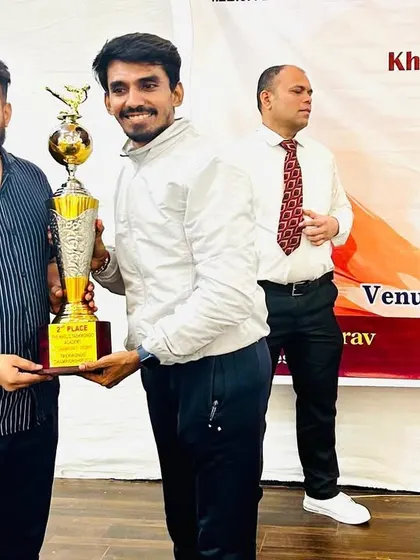 Receiving the 2nd place team trophy at the 5th Champions Trophy 2023 on behalf of my hardworking team.