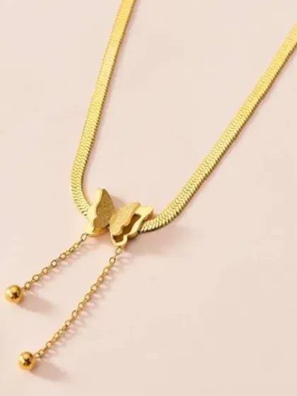 This unique lariat-style necklace features a butterfly pendant on a flat snake chain with dangling ends. It's an eye-catching piece that is both elegant and playful.