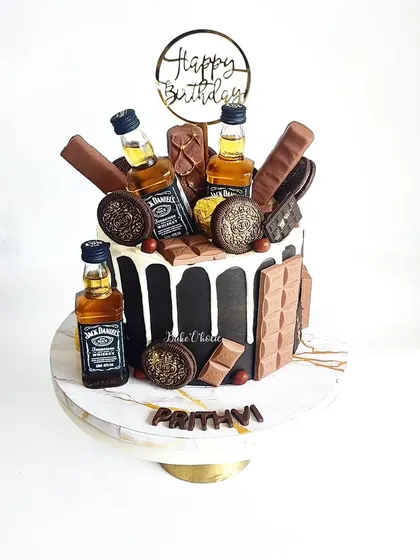 Another take on a chocolate and alcohol loaded cake. This one features mini Jack Daniel's bottles, Oreos, and lots of chocolate bars for a truly indulgent celebration.