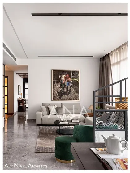 A perspective of the living room in Apartment 704, focusing on the seating arrangement. The clean lines of the sofa and the pop of color from the green chair create a simple yet elegant composition.