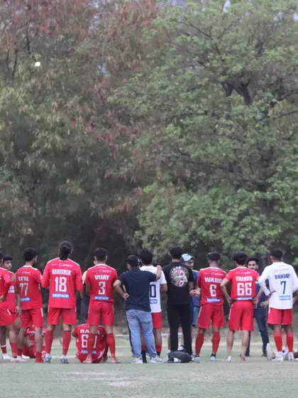 The team listens to the coach during a break in play. Tactical guidance and team cohesion are key elements of our success.