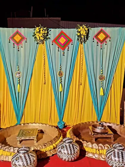 A simple and elegant coustamised decor for a Haldi ceremony. We used yellow and teal drapes with traditional hangings to create a vibrant and joyful setting.
